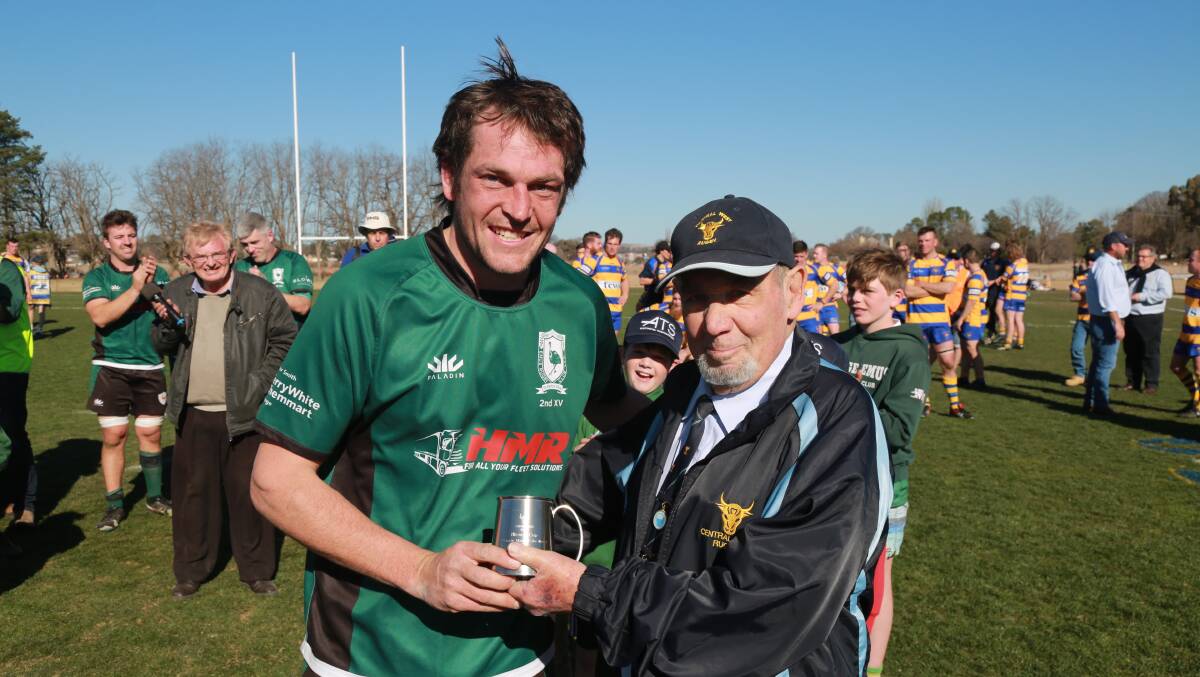 MAIN MAN: Orange Emus' Harry Hamilton is presented the man of the match award by former Central Western Rugby Union CEO Peter Veenstra after the Blowes Clothing Cup second grade grand final. Photo: PHIL BLATCH