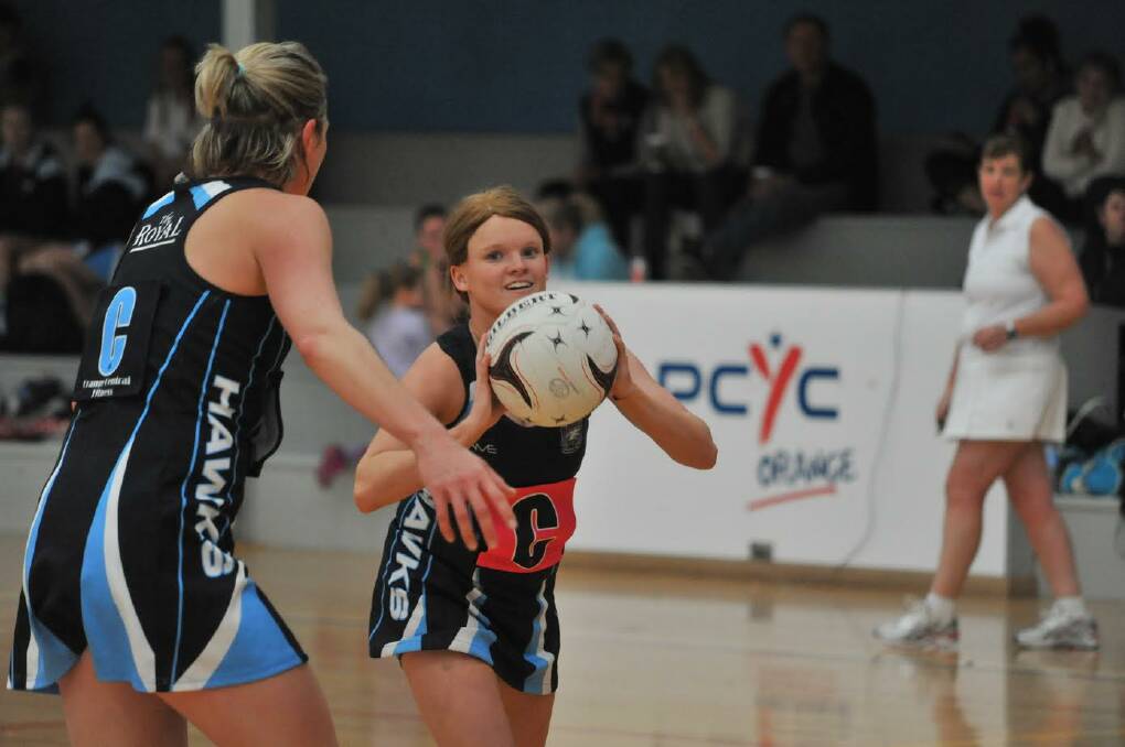 PRECISION PASSING: Hawks Royal player and Central Fitness coach Tash Rudd scans the court for options in her side's local derby earlier this season. Photo: JUDE KEOGH