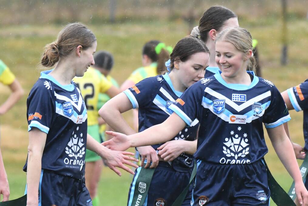 STOKED: Lilly Martin (right) and Orange Hawks produced an emphatic 22-0 shutout of their grand-final rivals on Saturday. Photo: CARLA FREEDMAN