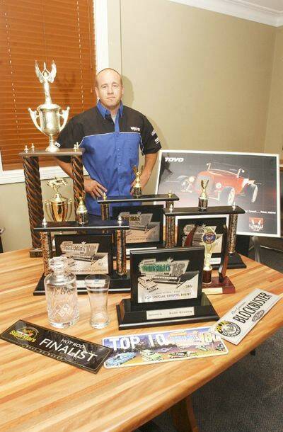 SPOILS: Mick Fabar with the spoils of his trip to Canberra for the 2005 Summernats. Photo: JUDE KEOGH