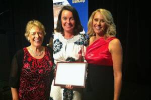TOP PRIZE: Award judge Kathy Hirschfeld (left) and news presenter Tracey Spicer (right) present Christine Weston with her spirit of community leadership award for her work on the tourist project Animals on Bikes.