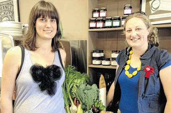 LOCAL SUPPORTERS: A Slice of Orange’s Lisa Lovick and Katie Baddock from The Farm Gate by Nashdale Fruit Co plan to only eat locally-produced and made food this week. Photo: TRACEY PRISK