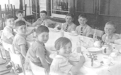 HAPPIER TIMES: Ian Bayliff (far left at top of table) with other children destined for Fairbridge Farm aboard the  SS Strathnaven on their way to Australia.