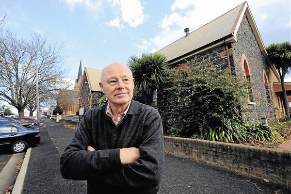 FURIOUS AT FIRE SALE: Max Madden says he and other parishioners are angry the Bathurst diocese of the Anglican church is selling off Holy Trinity’s historic bluestone hall to claw back a massive debt. Photo: STEVE GOSCH 0629sgbluestone1