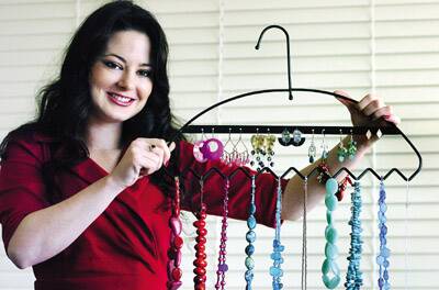 Local inventor Rachel Chippendale reveals her invention, a jewellery display hanger, after winning the regional category of the NSW BizStar competition on Tuesday.