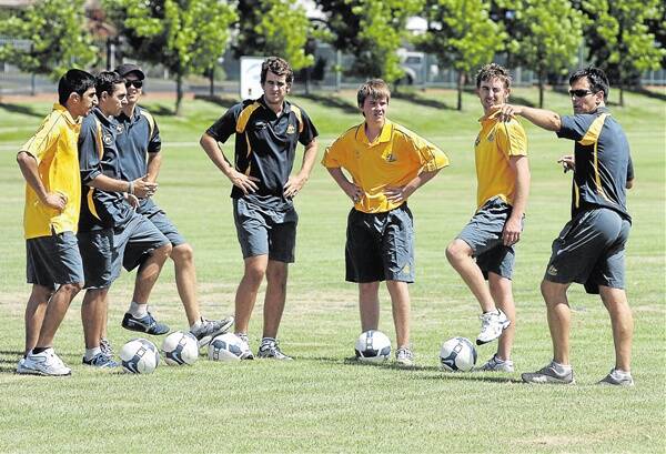 BACK FOR MORE: Australian Deaf Football coach Robert Stanton gives instructions to some of his players, including Orange’s Scott Simpson (third from right) and Blayney’s Mark Davis (second from right) at a training camp this January. The team will return to Orange next month. Photo: STEVE GOSCH