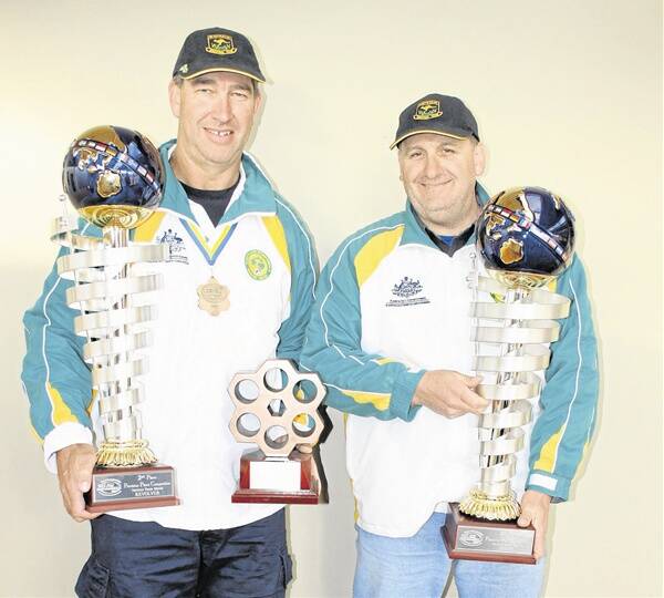 IMPRESSIVE HAUL: Orange pistol shooters Dean Brus and Dave Oates with their trophies they won at the World 1500 Championships in Sweden.