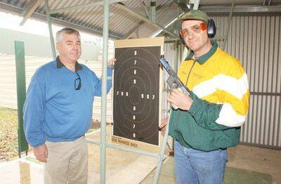 ORANGE SUCCESS: NSW Pistol Association president Ryan Cheers with Orange shooter Dave Oates at the state service pistol championships in Orange on the weekend. Photo: JUDE KEOGH