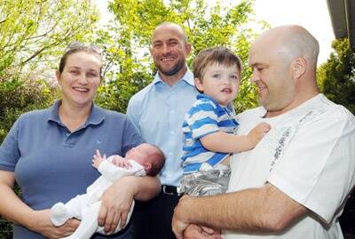 HAPPY FAMILY: Matt Dean (centre) has handed over the proceeds of his challenging charity bike ride to Lesa, baby Isabella, Harrison and Jamie Stedman.