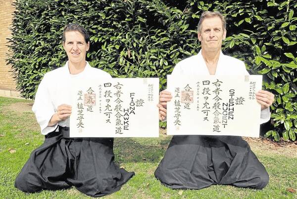 STEPPING FOURTH: Fiona Hawke and Stephen Nugent with their fourth dan certificates. The pair have trained for 20 years in Aikido Kenkyukai to achieve their fourth dans. Photo: JUDE KEOGH