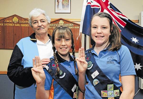 IN WITH THE NEW: Central West Trefoil Guild advisor Temple Cornish said removing references of God and Queen in the Girl Guide promise is not right, She is with Orange Girl Guides Hannah and Molly Marsh who will soon undertake the new promise. Photo: JUDE KEOGH 				                          0706guides1 to 4