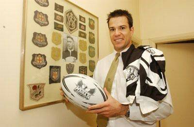 HUGE HONOUR: Ben Keegan (pictured), whose grandfather Alan Ridley was named in the Western Suburbs’ team of the century recently, with some of the memorabilia from the former Magpies winger’s career. Photo: JUDE KEOGH