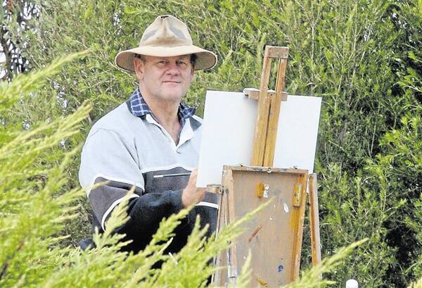 VIEW FROM MOUNT: Ted Lewis painting a scene overlooking the city from Mount Lindsay. Photo MARK LOGAN 0414mllewis