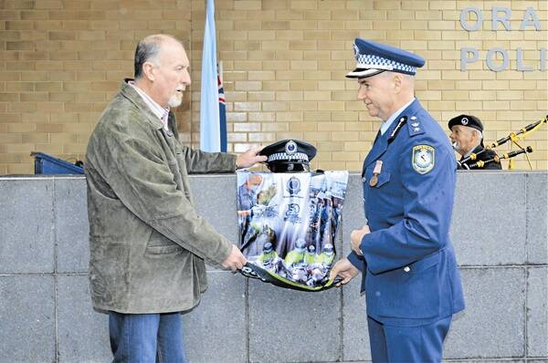 IN MEMORY: Canobolas Local Area Command (LAC) manager John Pirie, whose police officer father was killed while on duty, and Canobolas LAC commander Superintendent David Driver unveil a plaque in memory of Constable William Havilland at a memorial service on Saturday. Photo: NADINE MORTON 0616nmhaviland6 