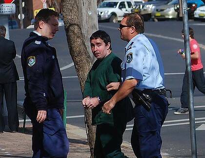 ice leading alleged hacker David Cecil into Cowra Local Court today. Photo: Andrew Fisher/Cowra Guardian