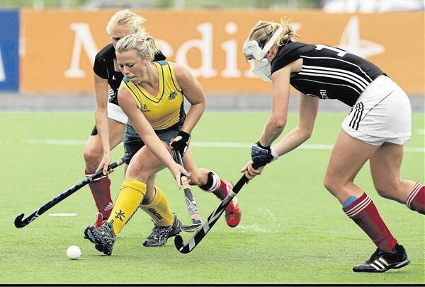 GAME FACE: Jade Warrender takes on a German opponent in her debut tournament for the Hockeyroos in Mendoza, Argentina in February. Photo: REUTERS