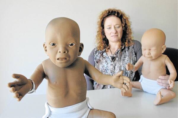 WARNING LABELS: Lyndon Community outreach team member Michele Campbell with a foetal alcohol-affected baby (left)  and drug-affected baby.