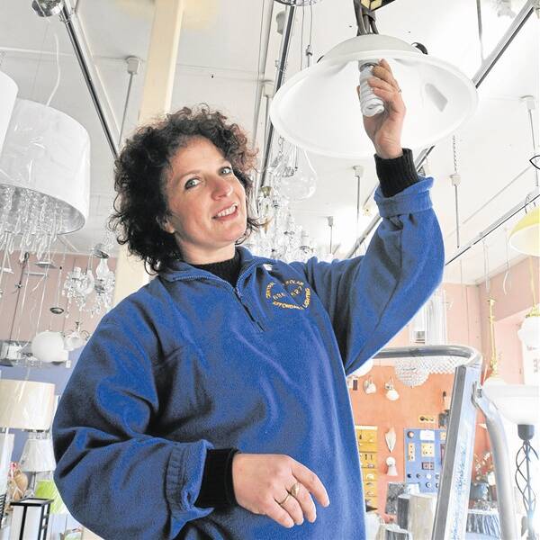 SWITCHED ON: Affordable Lighting’s Roumy Ivanova installs in a compact fluorescent light bulb.