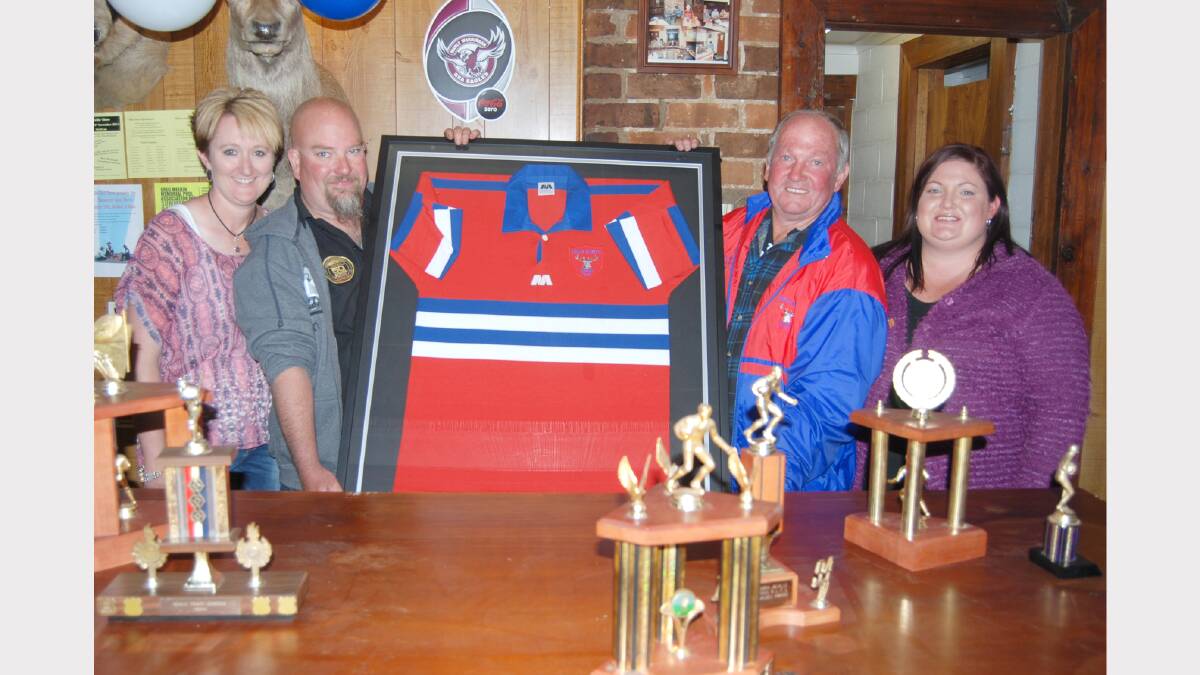 Reunion organizers, Gerry and Jason Hunter, Peewee and Hayley Read were happy with the roll up that attended the Neville Pub on Saturday night and show off a rare framed Stags jersey as major prize in their raffle.  Photo: Wayne Cock.
