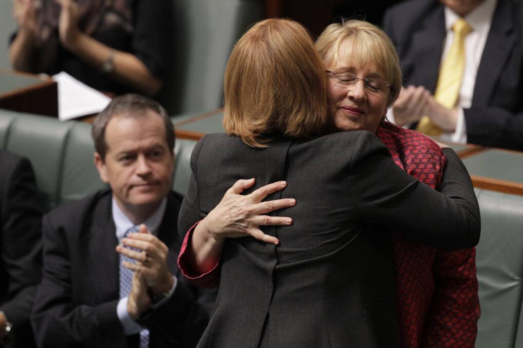 An emotional Prime Minister Julia Gillard hugs minister Jenny Macklin as minister Bill Shorten looks on after the introduction of the legislation to increase in the Medicare levy to fund DisabilityCare in Parliament House Canberra on Wednesday 15 May 2013. Photo: ANDREW MEARES