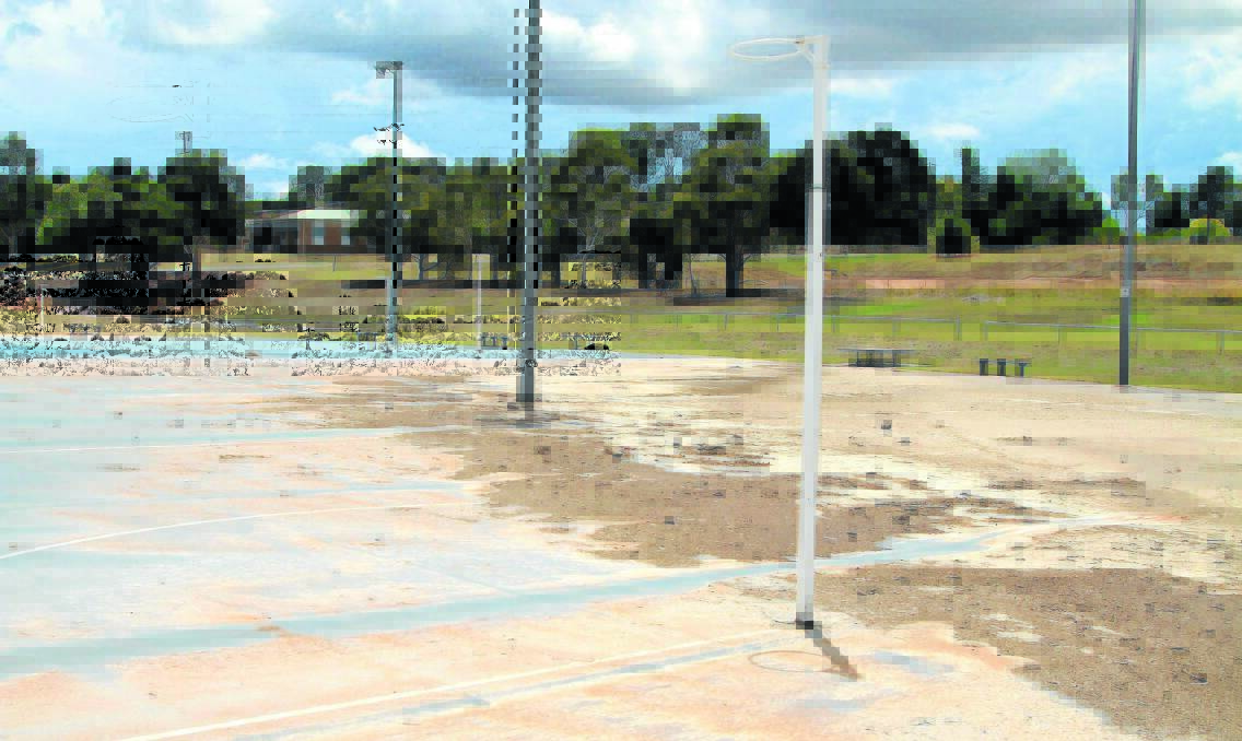 MUDSLIDE: Four of the eight netball courts at Anzac Park are covered in mud after the deluge over the weekend. Photo: JEFF DEATH   0127jdnetballmud01
