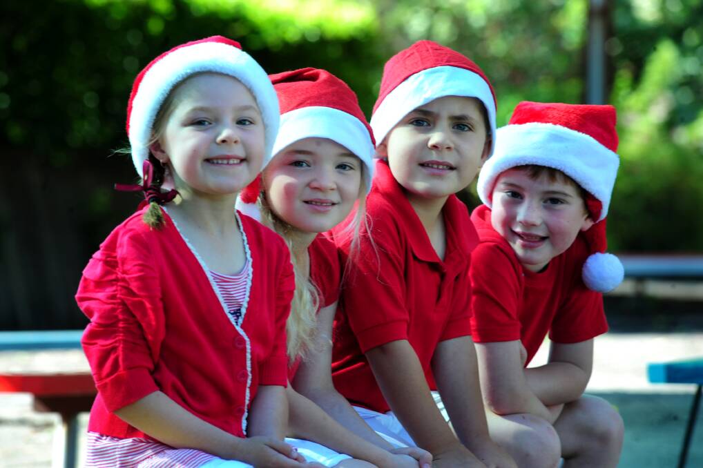 CHRISTMAS CAROLS: Catherine McAuley Catholic Primary School students Sophie Kearins, Piper Draper, Charlie Westgeest and Alex O'Brien are getting ready for the carol night tomorrow. 