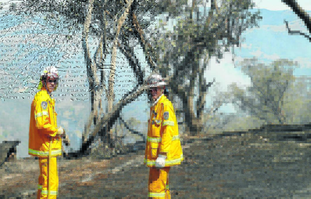 DEDICATED DUO: Father and son team Adam and Glen Griffith from Springside Rural Fire Brigade were at the Long Point fire yesterday, the fire has spread to 284 hectares of inaccessible terrain. 			               0102longpt8 