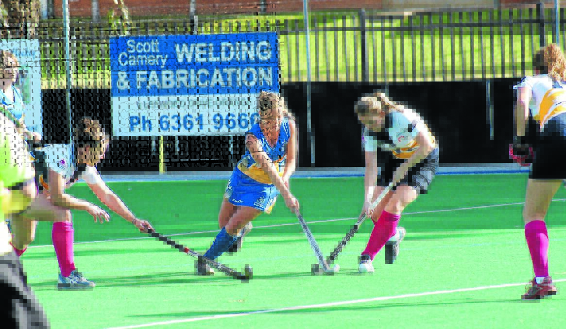 ALL-IN SCRAP: Ex-Services' Hayley Butcherine (left) and Kinross-CYMS' Laura Evans fight for possession during their match on Orange's PLH gala day in 2012. Photo: MARK LOGAN