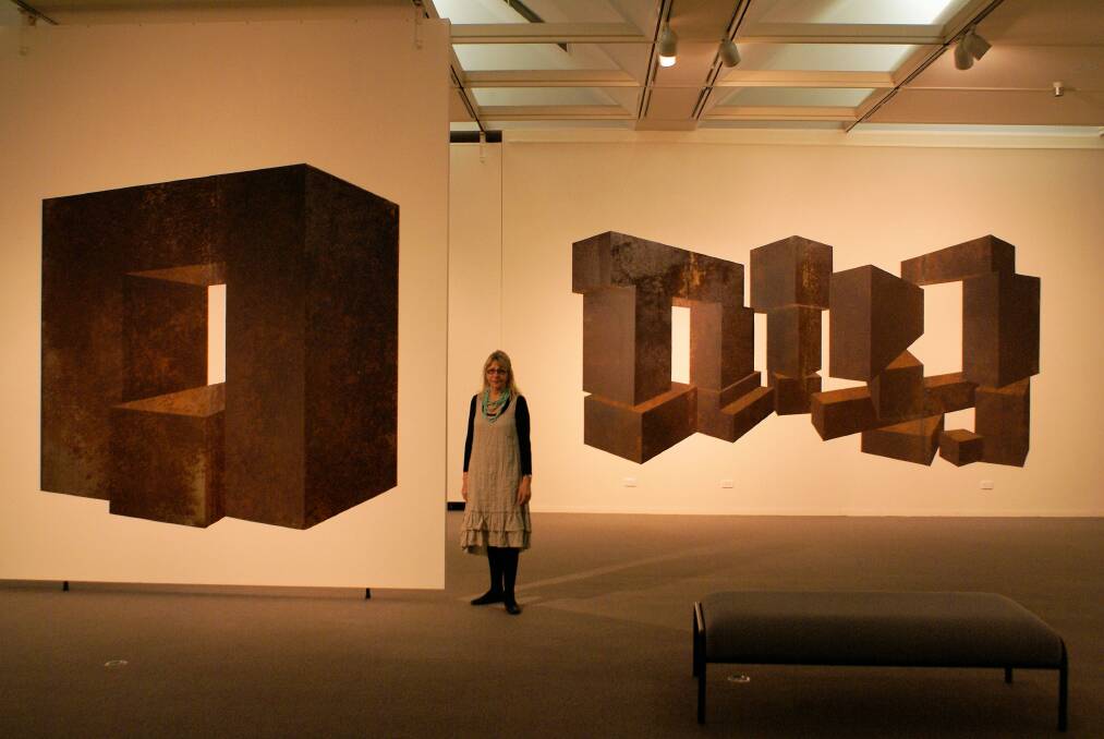 REMARKABLE: Gallery assistant director Brenda Gray with two works from Perspective Cutouts.                                                                 Selwoodinstall1.jpg