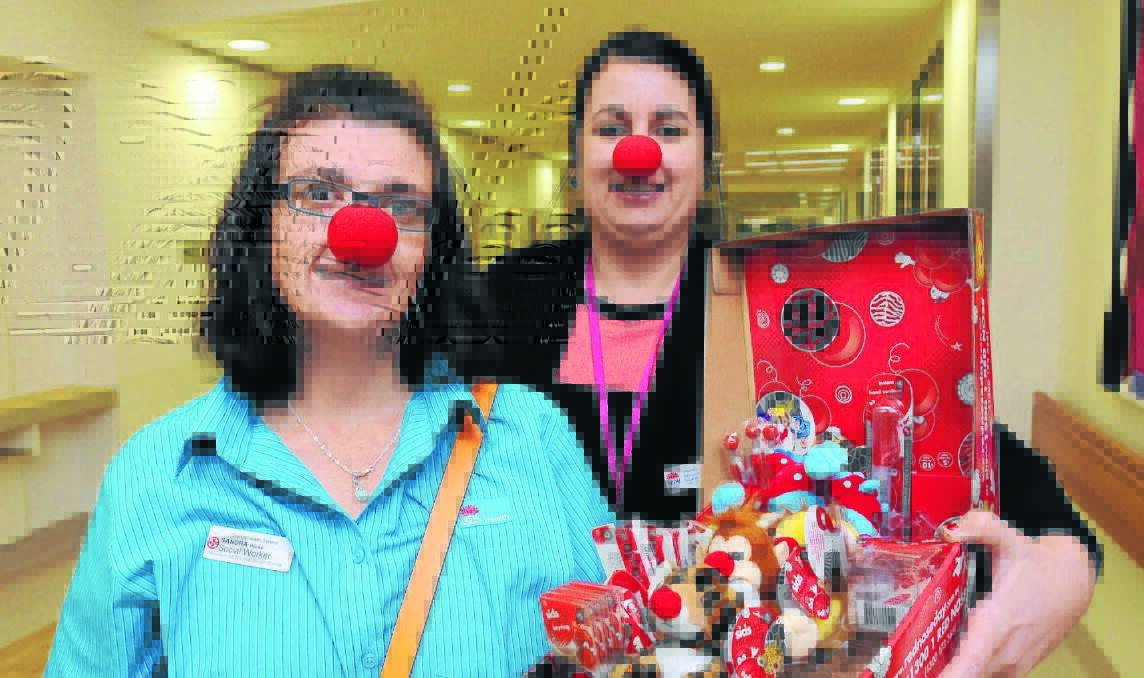 RED NOSE DAY: Orange Health Service social workers Sandra Wicks and Samantha Lyons are encouraging people to buy Red Nose Day merchandise to support the work of SIDS and Kids. Photo: STEVE GOSCH                                                                                      0625sgrednose2