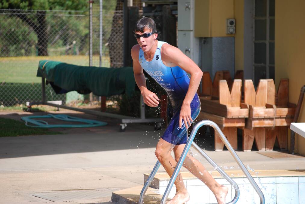 STEPPING OUT: Cowra's Luke Chalker makes his way out of the water during the Cowra Inter-Club Triathlon on Sunday. Photo: COWRA GUARDIAN
