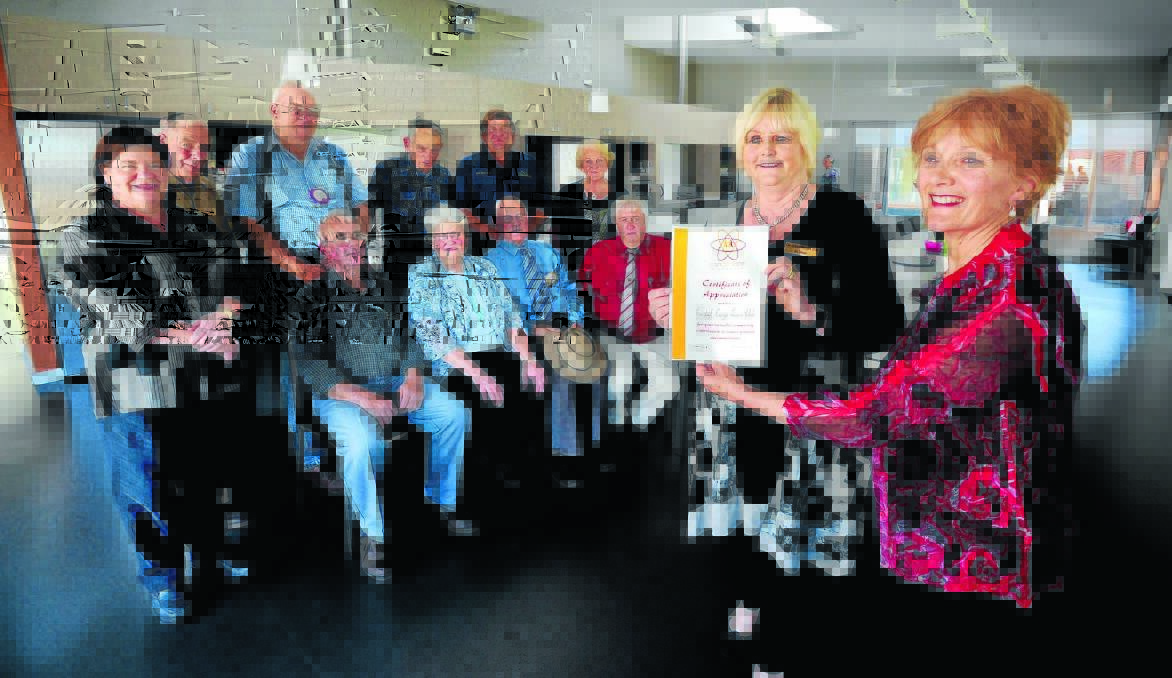 ACT OF KINDNESS: Western Care Lodge regional coordinator Jan Savage presents Lions Club of Cudal-Cargo District president Janet Price a certificate of appreciation as club members (back) Jenny Stephens, Dave Farrell, Darcy Callan, Kevin Frecklington, Richard Hazelton, Helen Constable, (front) Graham Eslick, Margaret Brien, Jim Brien and Dudley Frecklington look on. Photo: STEVE GOSCH    1005sgwestern 