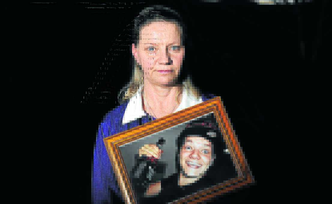 HAPPIER TIMES: Sharon Beuzeville holds a photo of her son Zac who she lost to suicide a month ago. She said this was how she wanted to remember him. Photo: STEVE GOSCH          0803sgbeuzeville