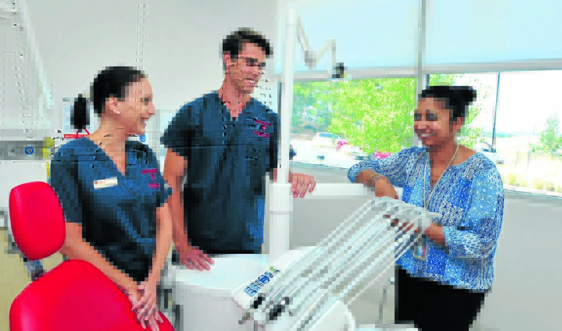 NEARLY THERE: Students Dee Ann Culverhouse and Shaun Day with associate head of the School of Dentistry at Charles Sturt University, Dr Sabrina Manickam, in one of the clinic rooms where final-year students have started back this week on their final phase of study before graduating as dentists. Photo: JUDE KEOGH                                                                                                                                                                                        0205dentist2