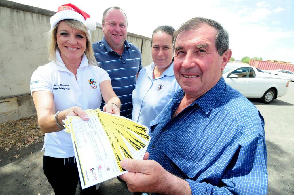 DUBBO: Jayne Bleechmore, Dubbo City Council's road safety officer, handing out taxi vouchers to Nino Patriarca (right) and staff Warrick Wheeler and Sharon Owens of Dubbo Terrazzo and Concrete Industries. Photo: LOUISE DONGES.