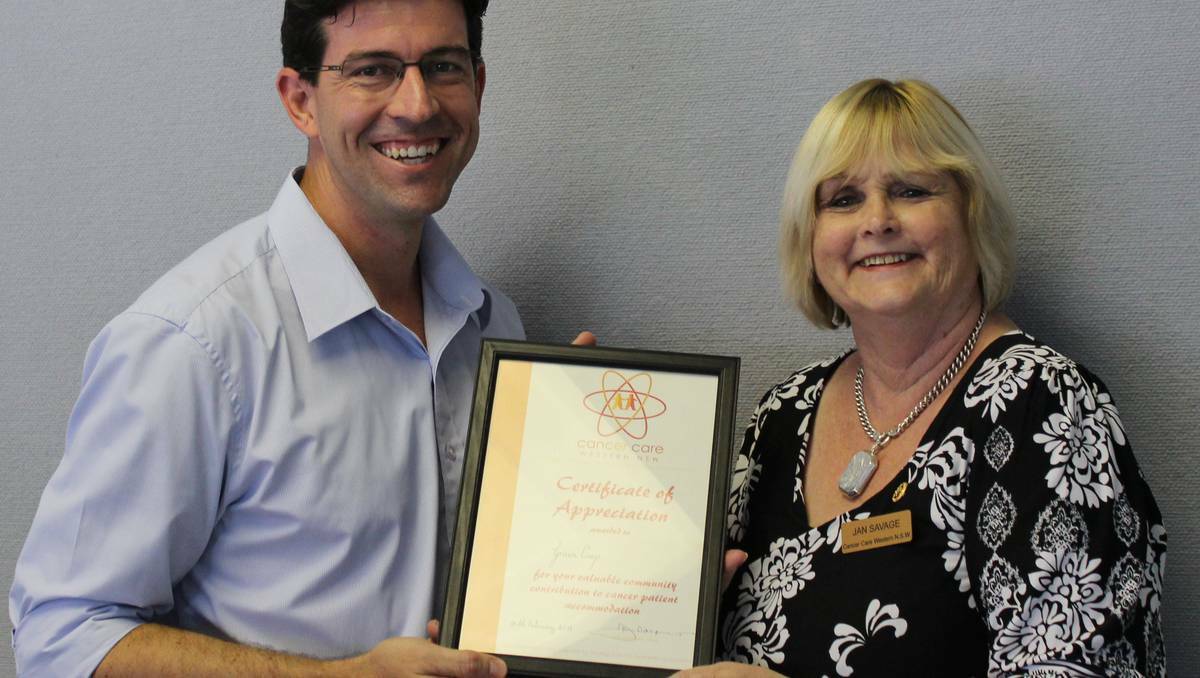 GrainCorp's Human Resource Partner Damien Pfeiffer being presented with a certificate of appriciation by Fundraising Chairwoman and Regional Coordinator of Cancer Care Western NSW Jan Savage. 