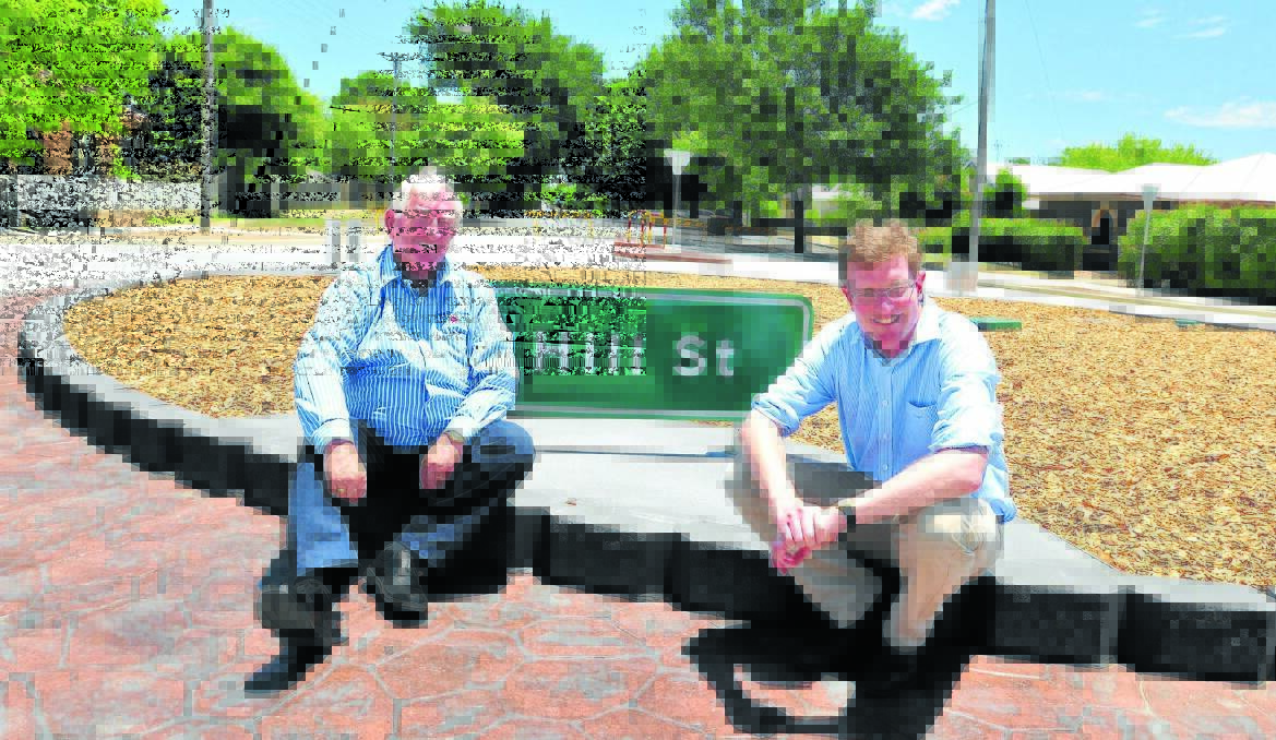 PARTNERSHIP: Orange mayor John Davis and member for Orange Andrew Gee celebrate today’s opening of the roundabout on the corner of Hill and Dalton streets. Photo: JUDE KEOGH 1221roundabout3 