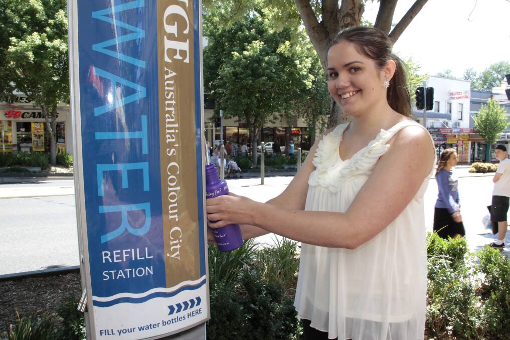 LITTLE BOTTLER: Hayley Penrose trying out the water bottle filling station and bubbler in Summer Street yesterday. Photo: JACK KEMP					                0115waterrefill.