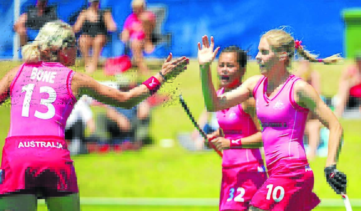 IN THE PINK: Orange's Edwina Bone (left) celebrates a goal with Hockeyroos teammate Rebecca Reuter during the International Super Series Hockey 9s in Perth. Photo: DANIEL CARSON