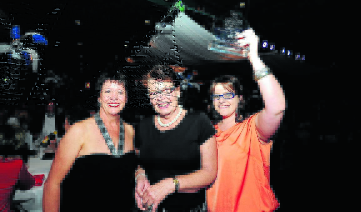 WINNING TEAM: Cathy Fitzsimmons presents Donna Thornton and Caitlin Haase from McCarthy’s Pharmacy with the top prize at this year’s CGU Orange Outstanding Business Awards. Photo: STEVE GOSCH                                                                                               1110sgwinners19