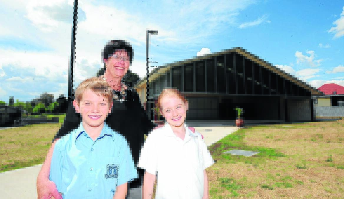 NEW POSSIBILITIES: Millthorpe Public School assistant principal Peggy O'Brien and students Fergus Connick and Tayla Hildenbeutel are excited about their new school hall constructed under the federal government's Building the Education Revolution (BER) funding. Photo: STEVE GOSCH                        1030sgmpshall1