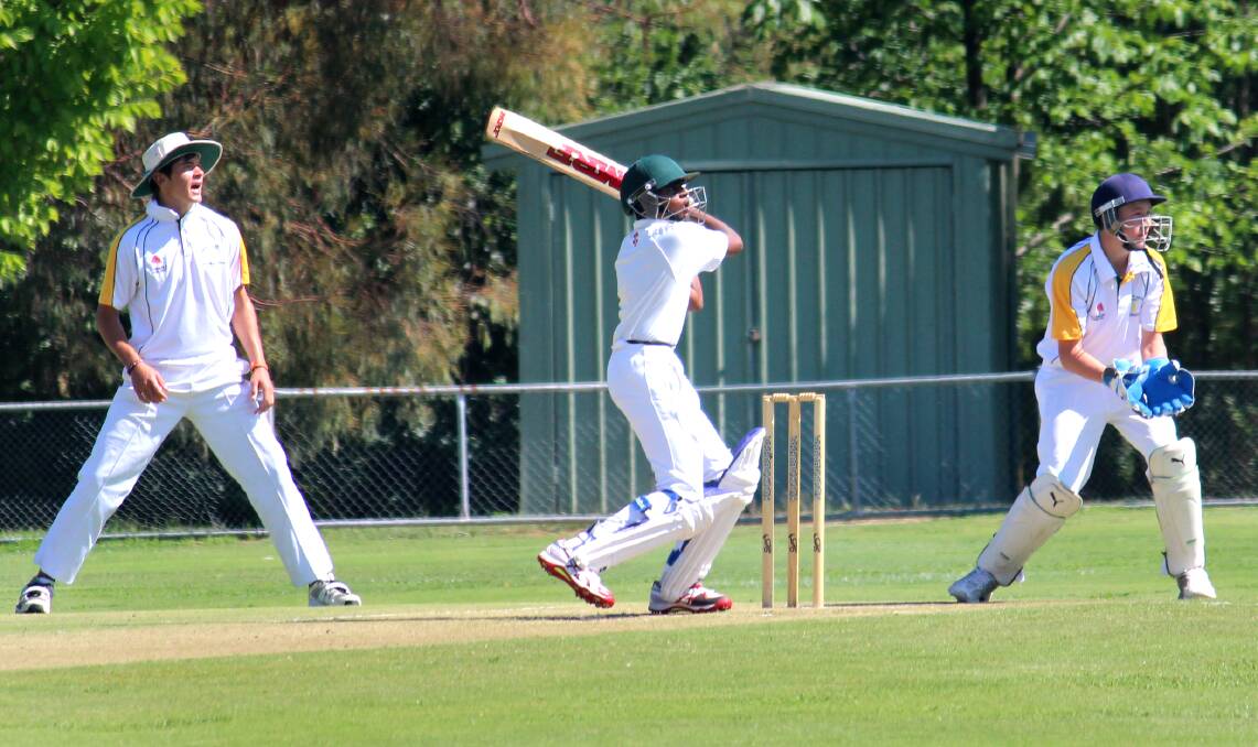 GO FETCH: Blake Harrison (wicketkeeper) watches on as Kris Weereratne smashes another delivery for four. Photo: MELISE COLEMAN 									      0115mccricket3