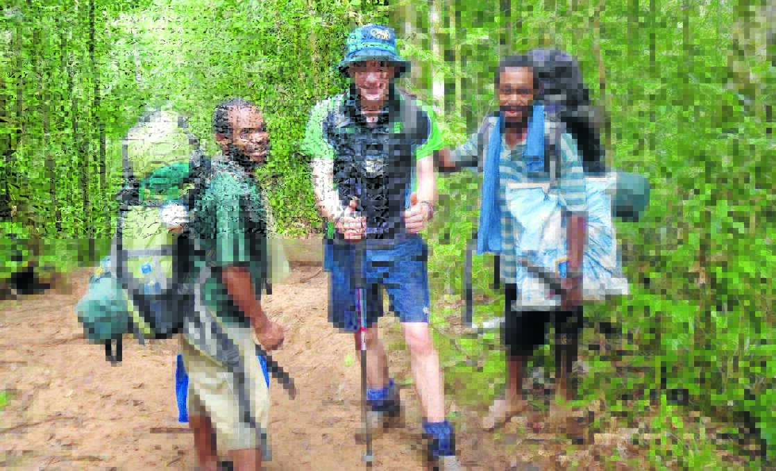 ON TRACK: Orange man Will Parish, with two indigenous guides, rates walking the Kokoda Track as one of his best achievements.  Photo CONTRIBUTED