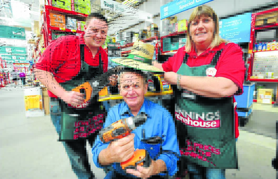 GENEROUS: Rural Fire Service (RFS) volunteer Ray Astill, with Bunnings staff Nathan Howard and Sue Rodwell, says he was shocked to hear the company was donating him a new set of tools to replace the ones stolen from a Rural Fire Service shed two weeks ago. Photo: STEVE GOSCH                                  1111sgray2