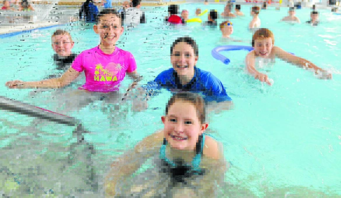 SPLASH OUT: It might have been cold outside but it didn’t stop Mitchell Myhill, Ashleigh Grimshaw, Bridget May, Annalese Mills, and David Elliot and thousands of others from enjoying the Orange Aquatic Centre during the cooler months. Photo: JUDE KEOGH. 1003pool1