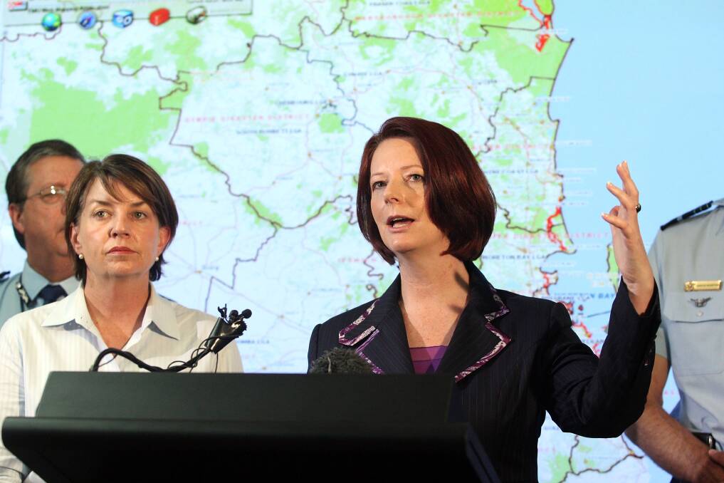 Queensland Premier, Anna Bligh stands alongside Julia Gillard as she makes a speech during the devastating QLD floods on January 12, 2011. Photo: Getty Images